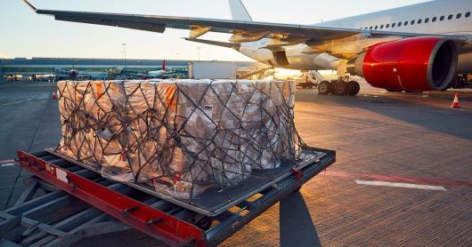 A slab of packages waiting on tarmak for aircraft loading