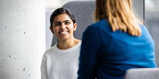 Undergraduate student smiling and chatting