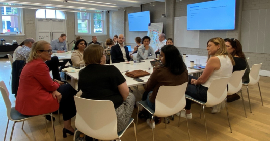 People sitting around a table at a workshop