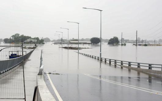 flood water from the hawkesbury river flowing over the new windsor bridge at windsor in nsw, australia in 2022