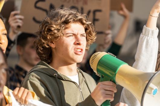 young person with a megaphone. Adobe Stock by Lomb