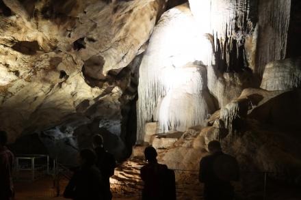 People viewing cave rock formation