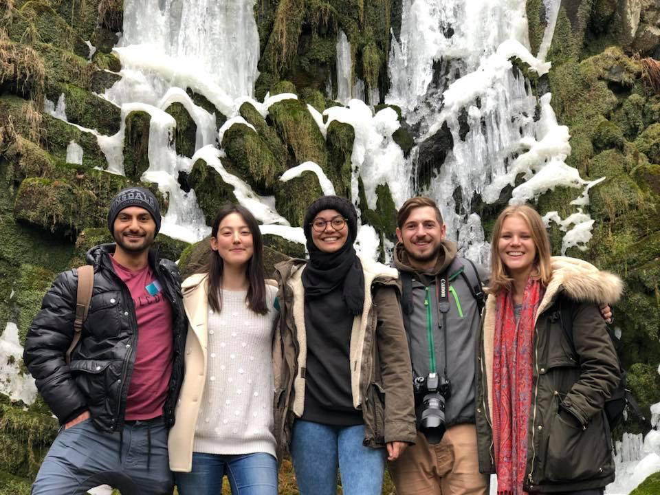 Students in front of a frozen waterfall in Germany