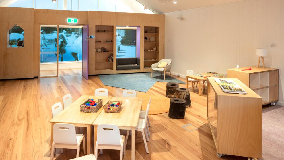 Low tables set up for children, shelves on wheels for a flexible playspace