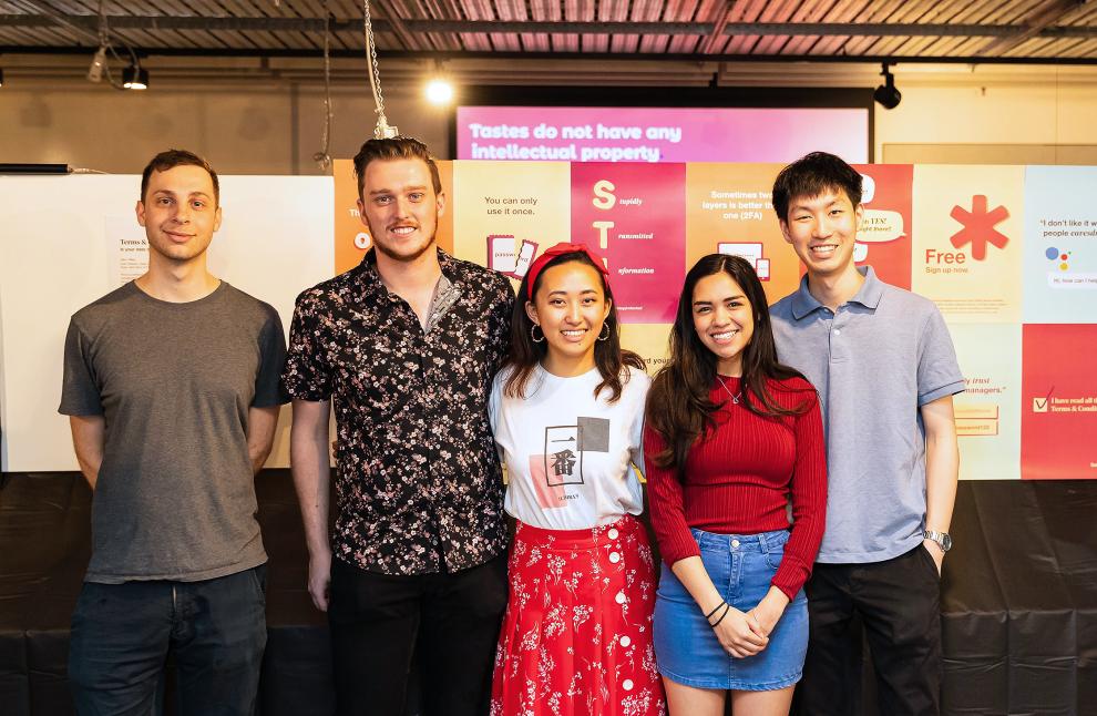 Five students in a group smiling for photographer at BCii market day 2019