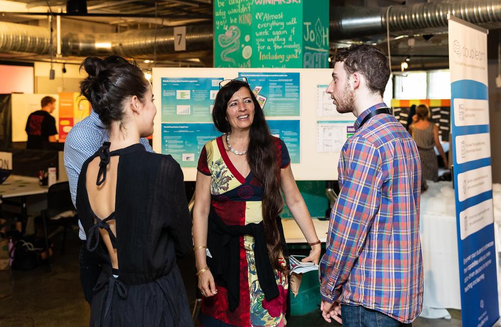 TD staff member talking to two interested students at BCii market day 2019
