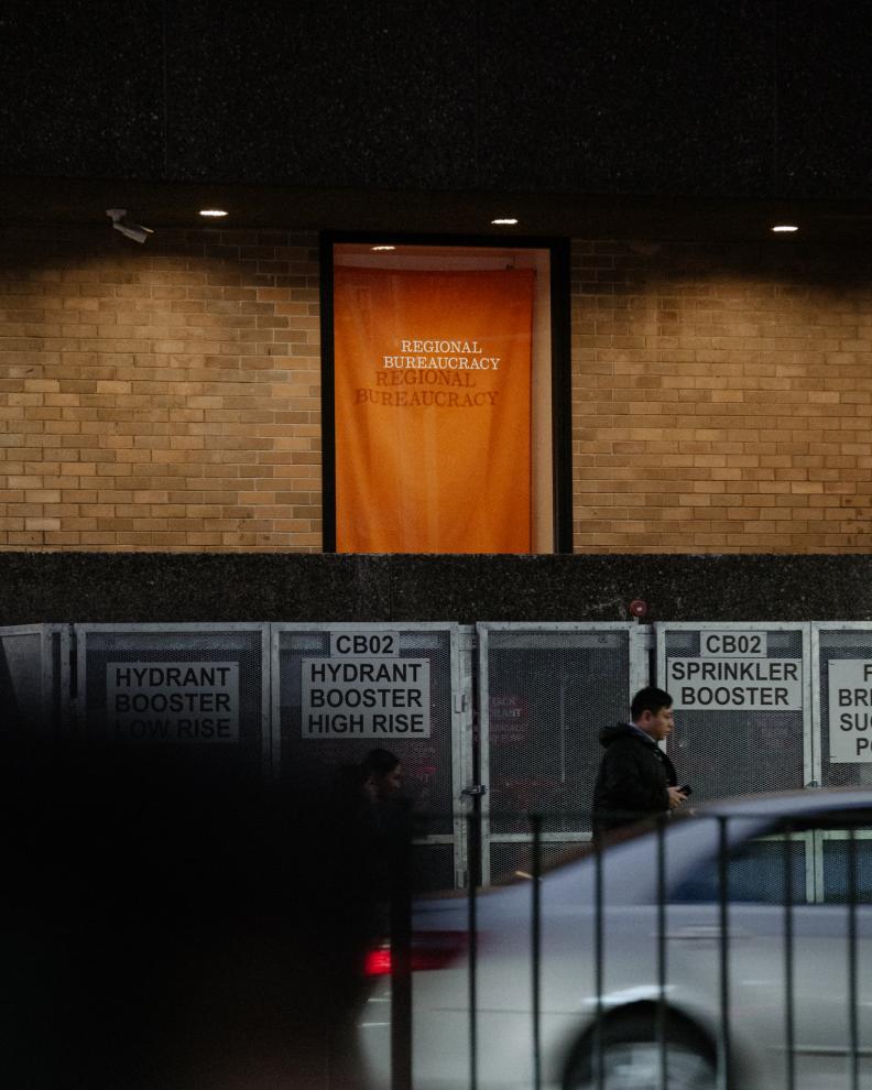 An orange flag hangs in a window