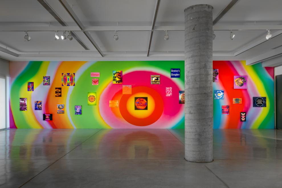 A rainbow wall with colourful posters