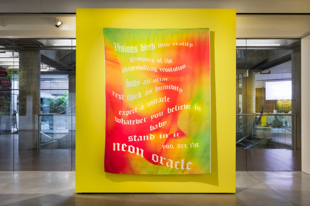 A textile work on a yellow wall