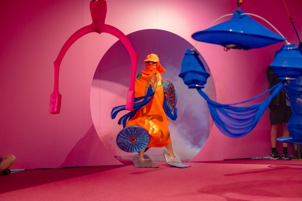 A person in an orange costume poses