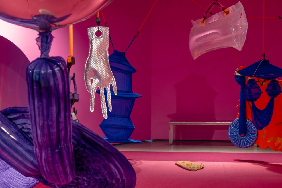 A colourful art installation in a room painted pink