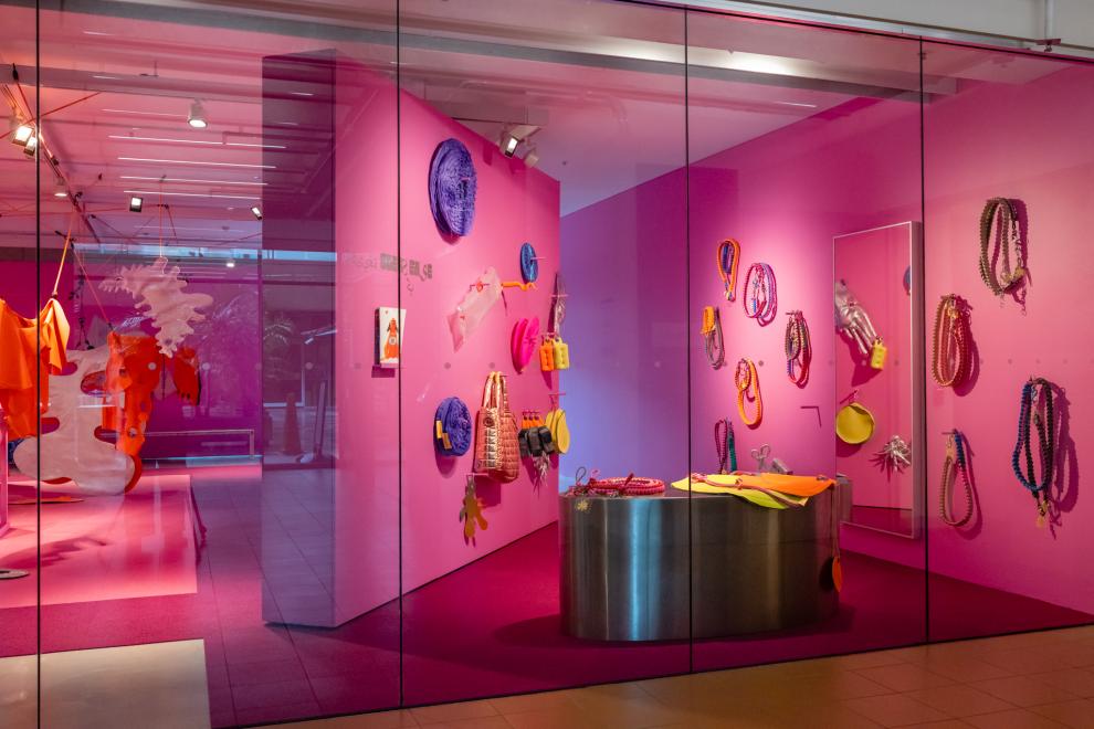 A display of colourful accessories in a pink shopfront