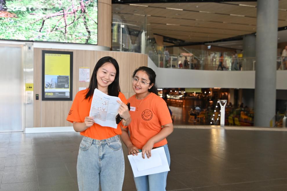 Two Peer Networkers reading from a page. 
