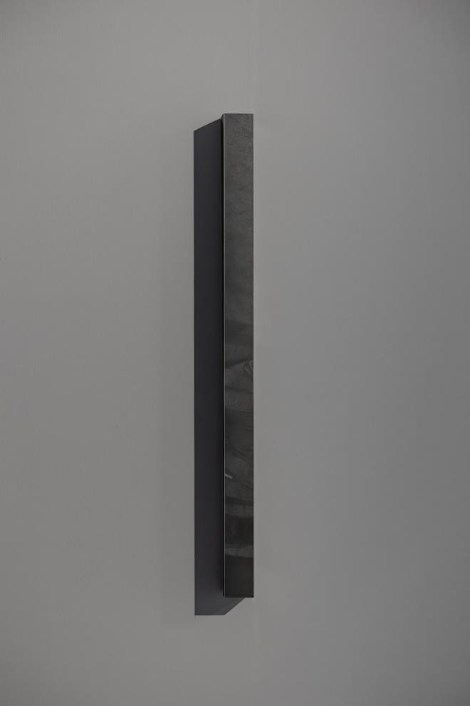 A graphite on paper artwork on a white wall 