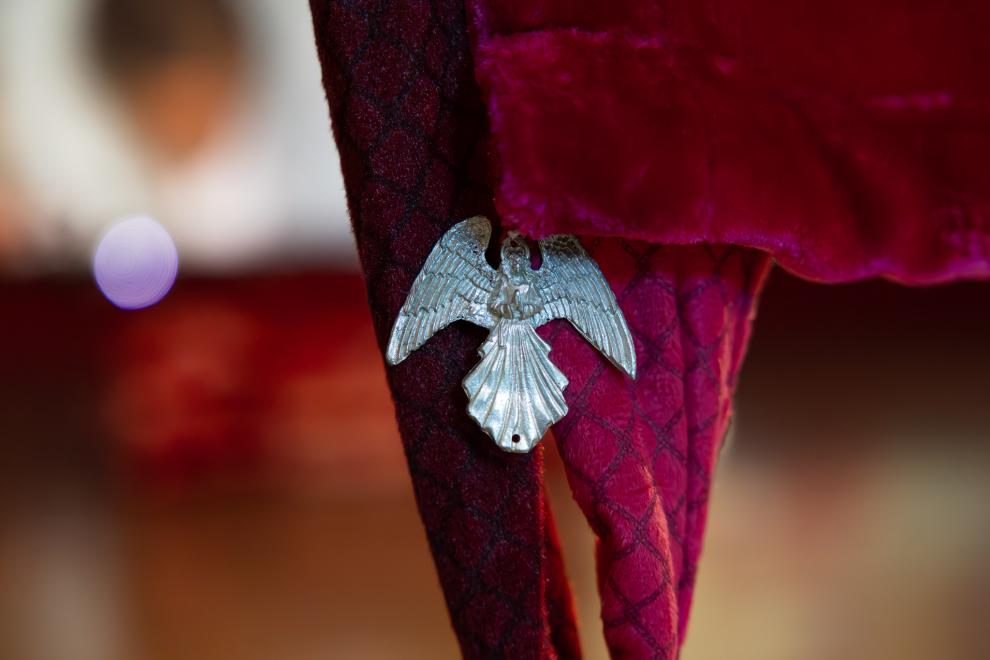 A close up photo of a silver angel charm
