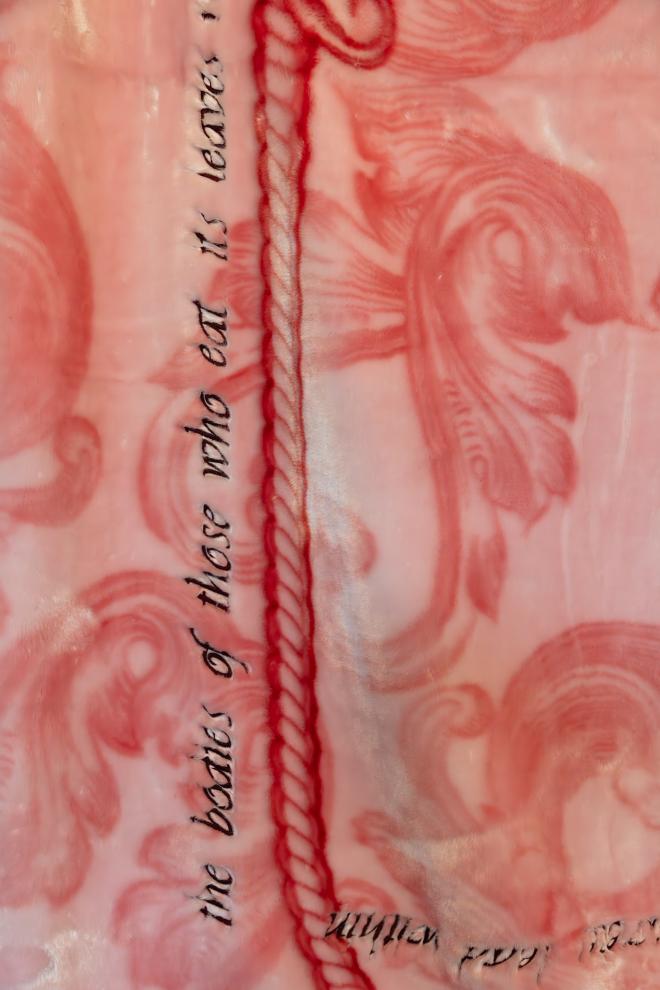 Embroidered text on an acrylic mink blanket