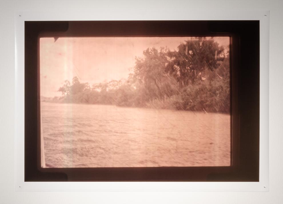 A photograph of an artwork showing a pink washed landscape