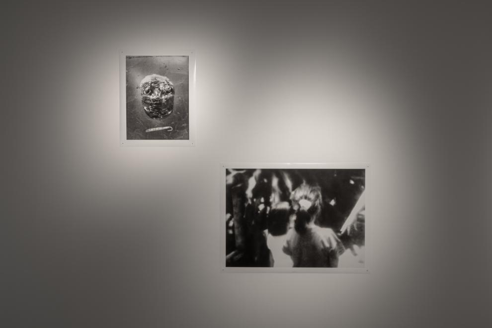 A photograph of two photographic artworks, one showing a museum artefact and the other two small girls facing away from the camera