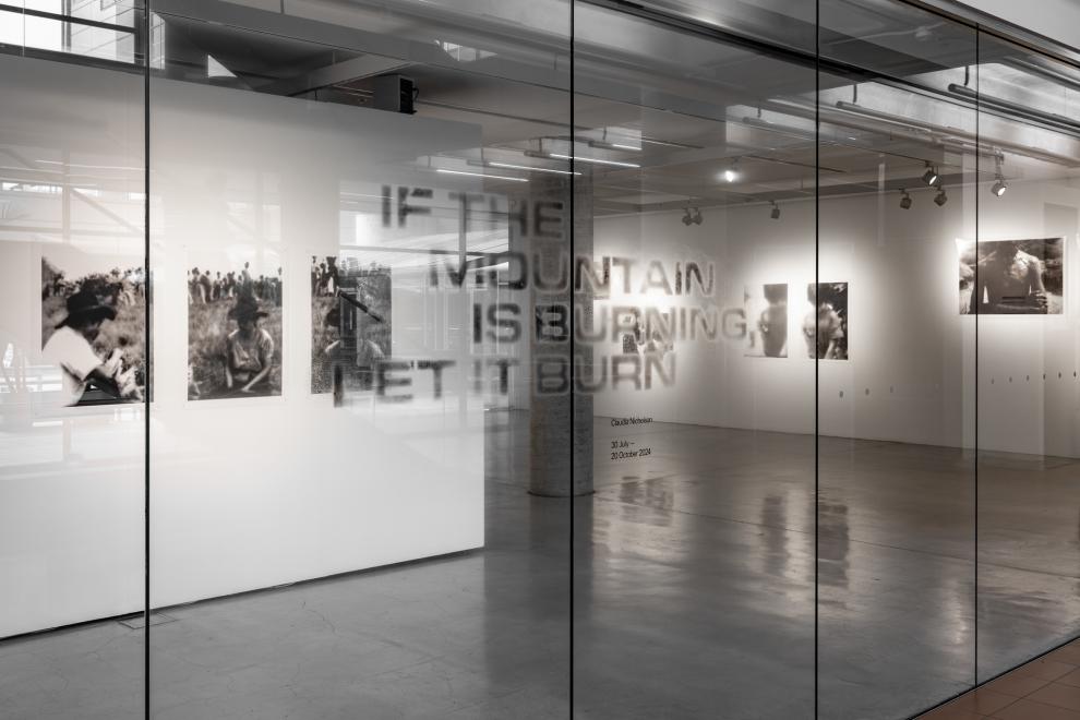A photograph of the exhibition title graphic which reads "If The Mountain Is Burning, Let It Burn"