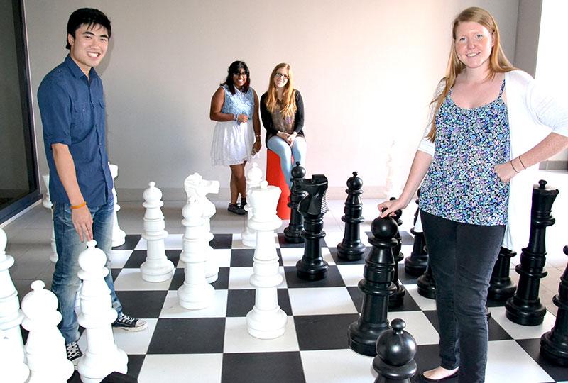 Four people with playing chess