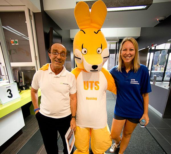 UTS Housing mascot with two people