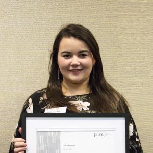 Female student holding award