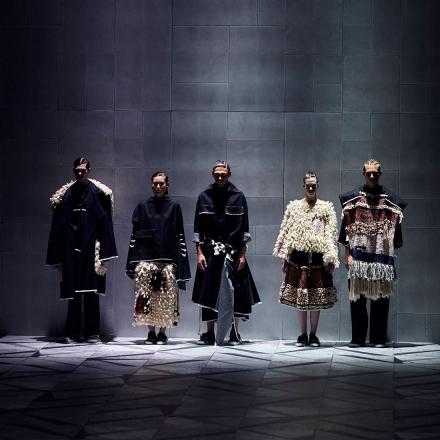 Five models stand side by side on the stage at the University of Technology fashion show