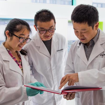 Researchers discussing the contents of a book