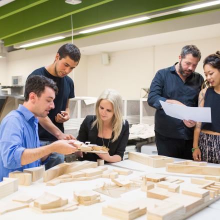 5 people working together on a architecture model