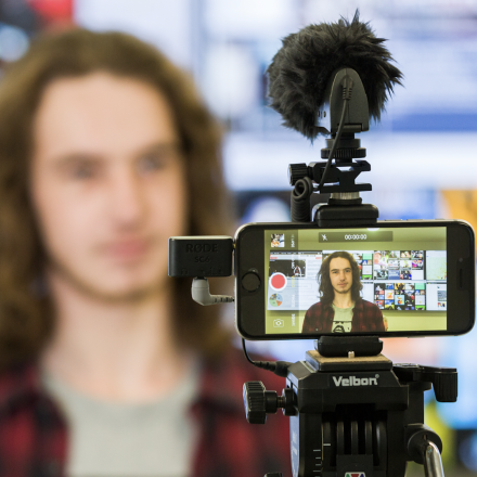 A UTS journalism student filming a story, using an iPhone on a tripod