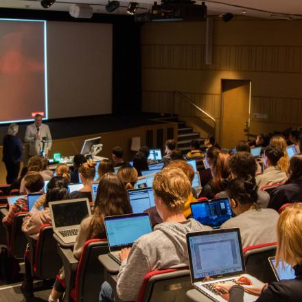 Peter Charley speaks in front of Journalism students in the Guthrie Theatre