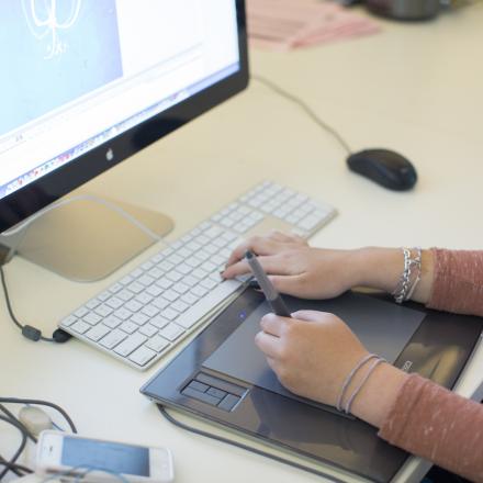 Design student at computer desk