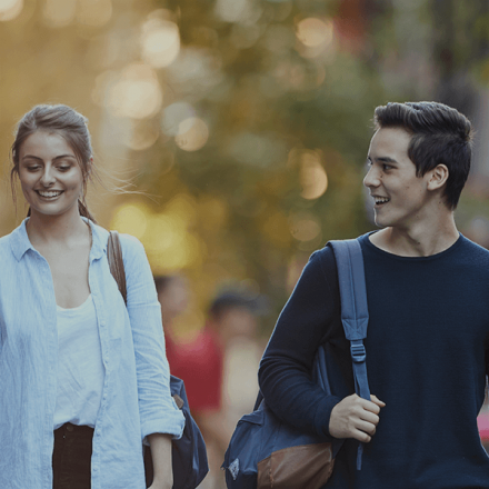 Female and male students walking on campus