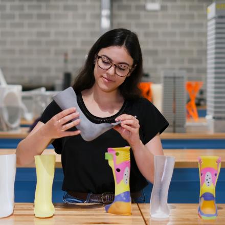 Mechanical and mechatronic engineering student Kate Leone holding a 3D printed ankle-foot orthosis.