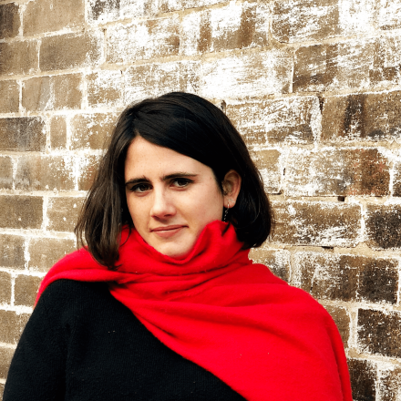 Victoria standing in front of a brick wall