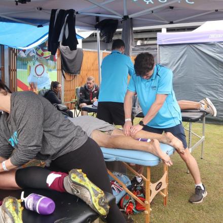 UTS Physiotherapy students Daisy, David and Jai massaging players.