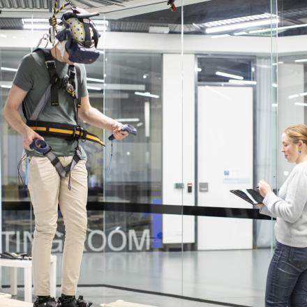 Guy with artificial reality headset walking on a elevated bench