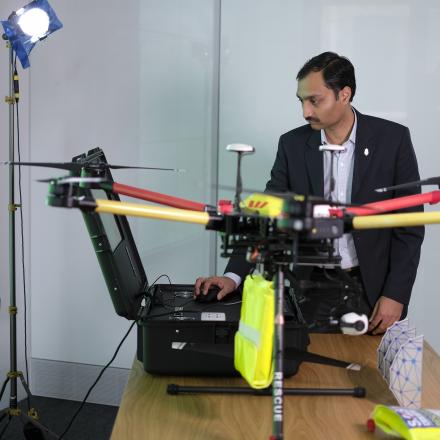 Man looking at drone on a conference room