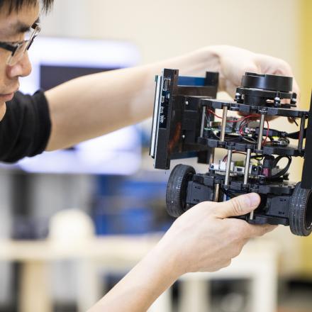 GUy handling a robot