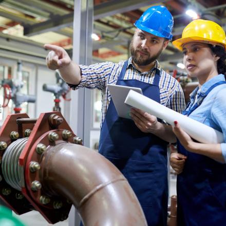 Engineers looking at a water pipe