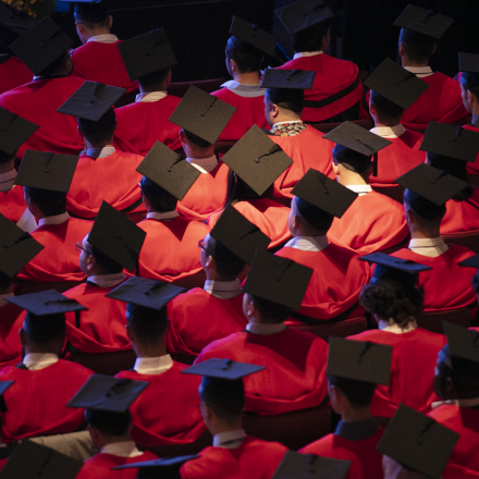 Top down view of graduates at the ceremony with their graduation caps