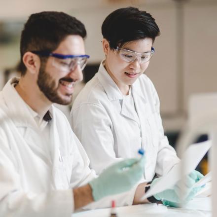 Students with safety glasses and lab coats 