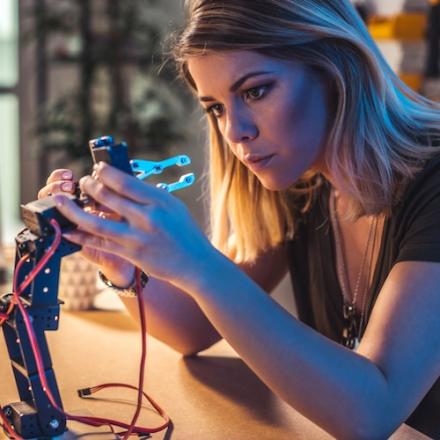 A female working on electrical components