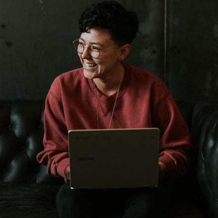 Laughing student with laptop