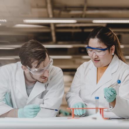 Two students conducting experiments in a science lab