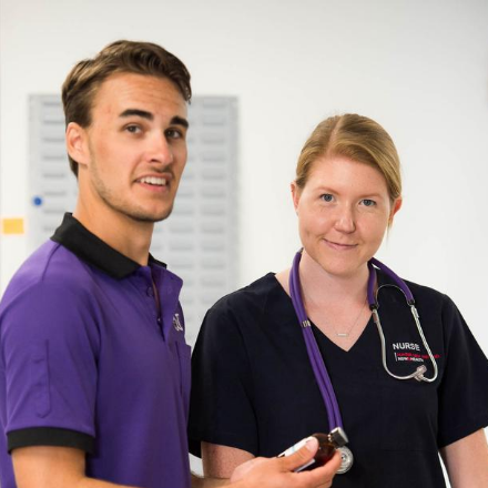 UTS Nursing student stands next to Registered Nurse