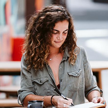 Student working at cafe table