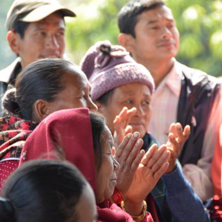 A group of people clapping 