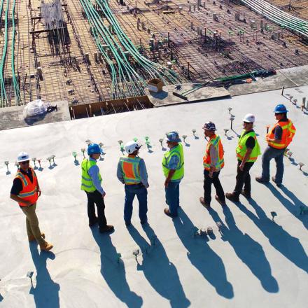 Construction workers plan and view building site