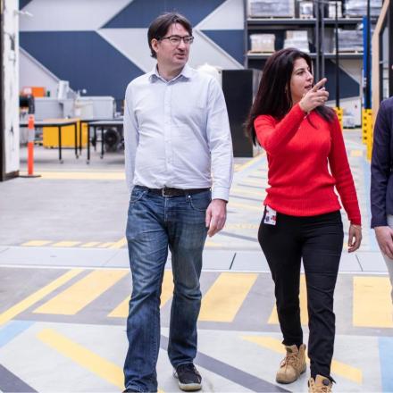 A man and two women walking through the UTS Tech Lab facilities